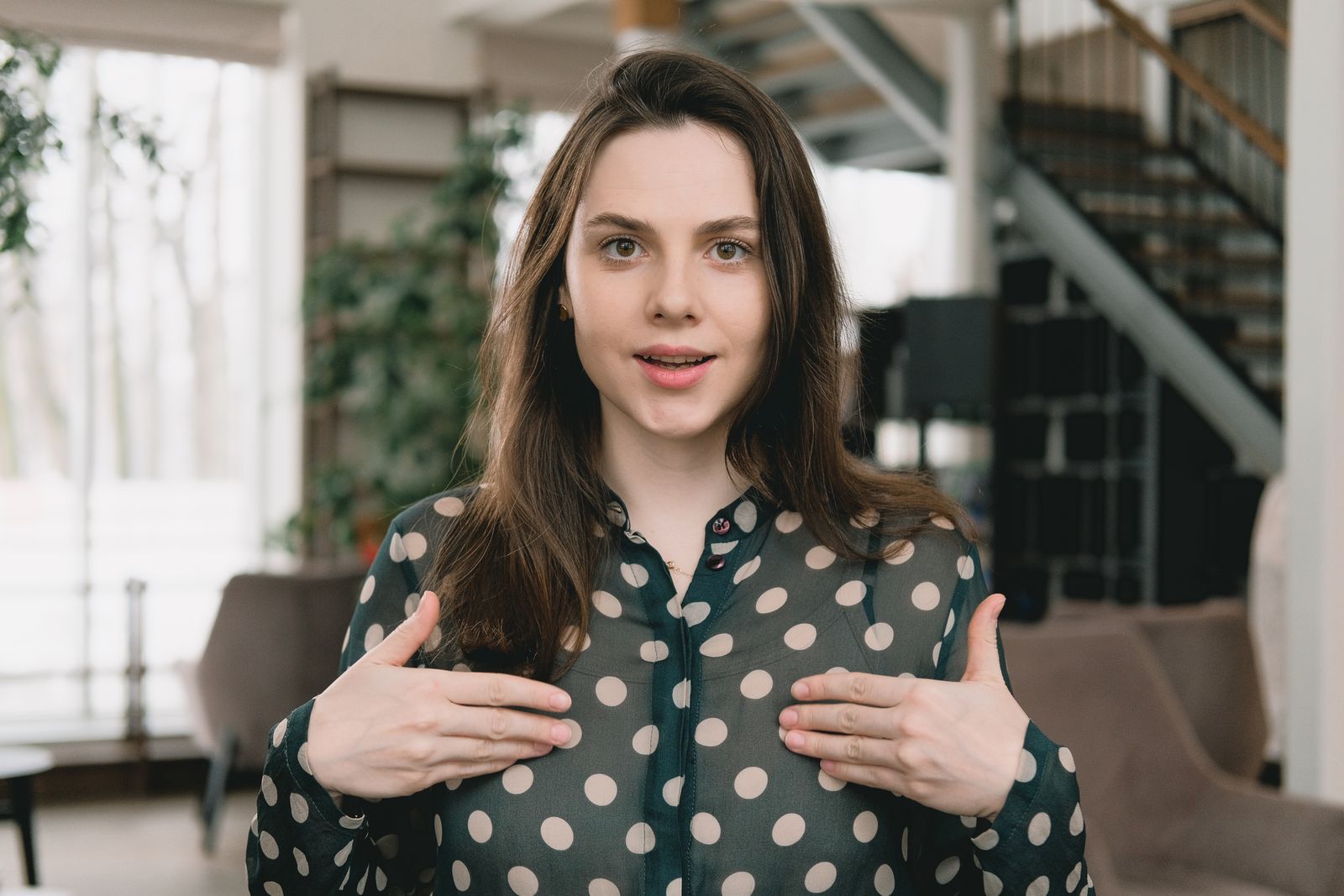 A female creator speaking directly to camera in a bright apartment
